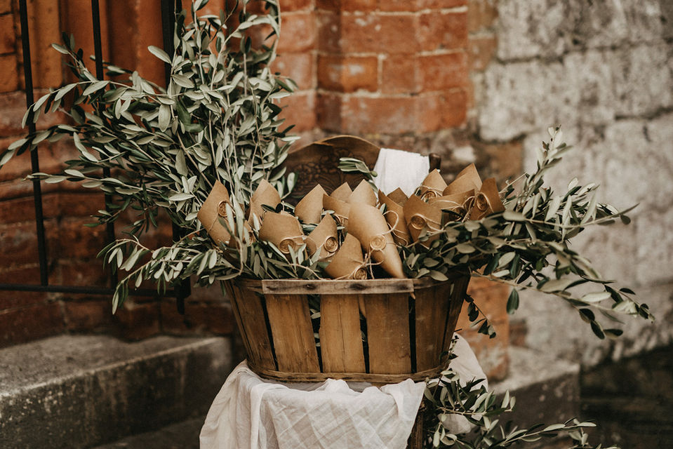 Sustainable wedding accessories for a destination wedding in Italy, olive leaves in a basket