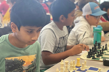 Kids playing chess in a scholastic tournament.