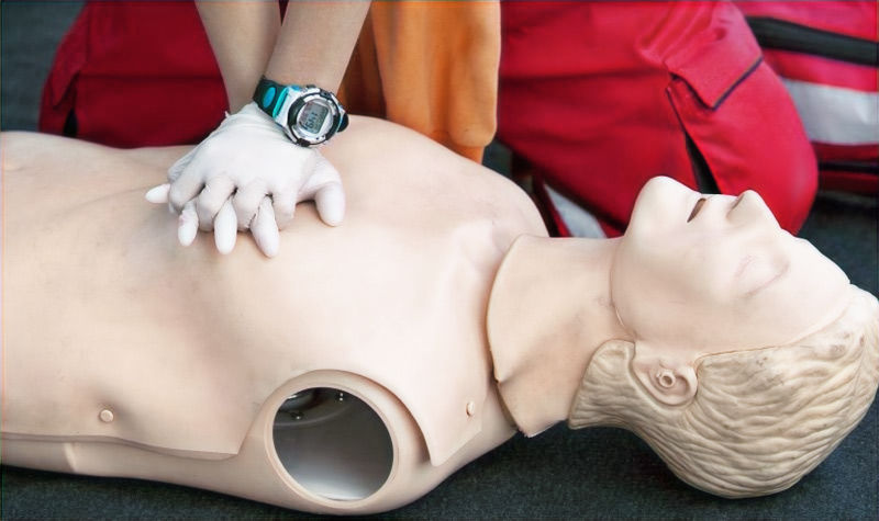 Emergency First Response (EFR) student practicing CPR on a mannequin.
