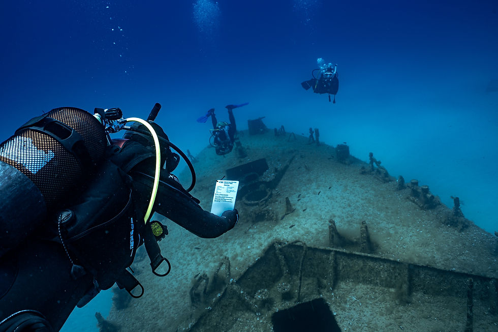PADI Master Scuba Diver exploring a shipwreck underwater.