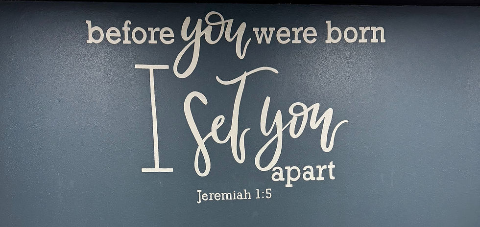 Eye-level view of a hand-lettered faith quote on a wooden wall