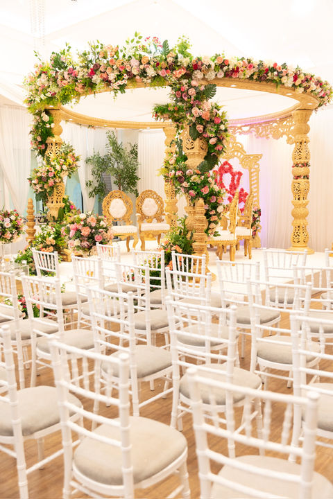 The Ganesh Mandap, graced with vibrant floral decor and the auspicious presence of Lord Ganesha, offers a sanctified space for joyous celebrations, ensuring blessings and prosperity for the union, Wedding Mandap Hire, Leicester, Venue- Winstanley House Leicester