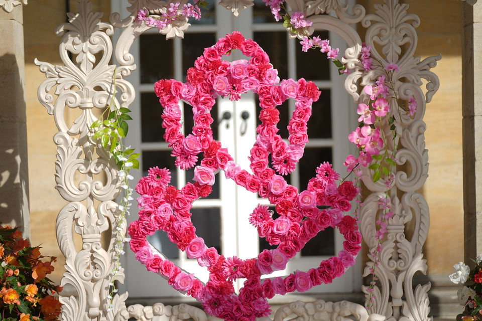 The Eternal Harmony Mandap, exquisitely adorned with lush floral arrangements, symbolizes the timeless union of souls, creating a serene and harmonious ambiance for the celebration of everlasting love - Wedding Mandap Hire