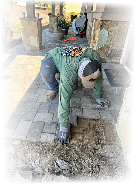 Raptors Edge crew member repairing a residential paver walkway