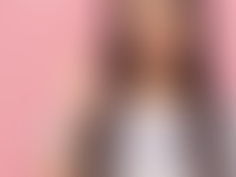 Girl on a pink background making an "okay" sign with her hand.