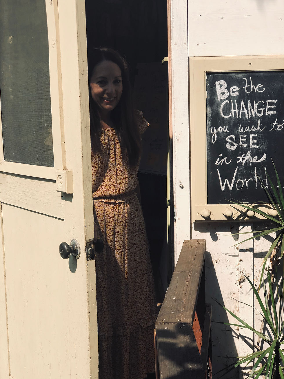 Erin Iler, Blogger, Educator, Mother, and Homesteader stepping out of her one room Schoolhouse
