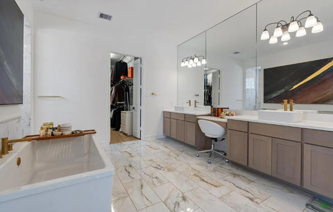 Modern walk-in shower with frameless glass enclosure, white subway tile, and black fixtures in a Houston, TX bathroom remodel. Luxury shower design by Bager.