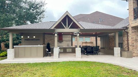Custom outdoor kitchen design with built-in grill, stone countertops and covered patio for a residence in Houston, Katy, Cypress, Tomball and The Woodlands, TX, designed and built by Bager LLC for modern backyard entertaining.