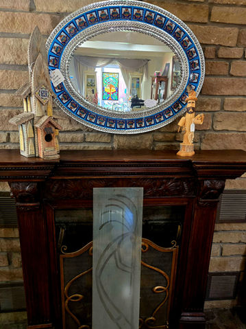 oval antique mirror, church and priest on mantle
