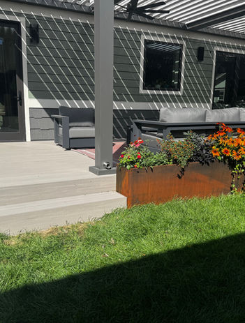 Modern concrete patio stairs with colorful flower beds and lawn in Littleton, Colorado.