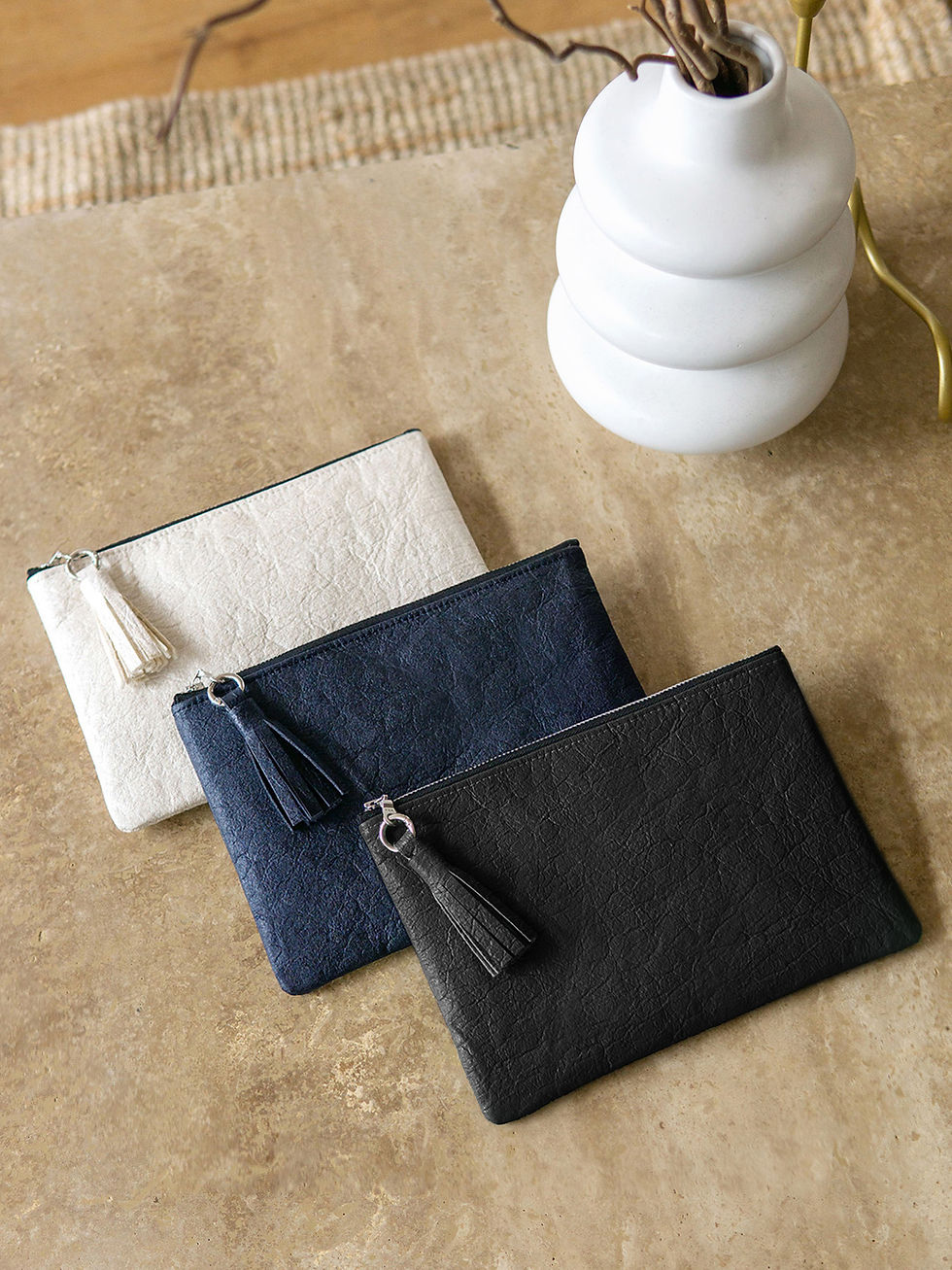 Thumbnail: Overhead view of three piñatex tassel zip pouches in different colours