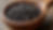 Close-up view of black peppercorns in a wooden bowl
