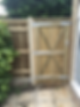 Sturdy wooden garden gate installed next to a closeboard fence panel