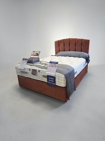 Rust-red upholstered divan bed with tufted headboard, priced at £1,749.99