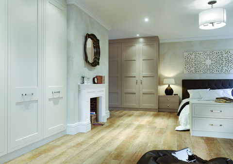 Spacious bedroom with light grey wardrobes and wooden flooring