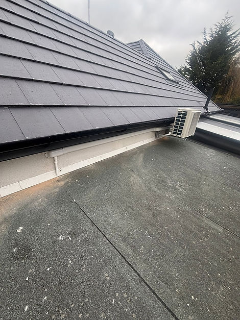 A black tiled roof featuring a single window, showcasing a modern architectural design
