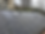 Slate roof with multiple skylights under a cloudy sky