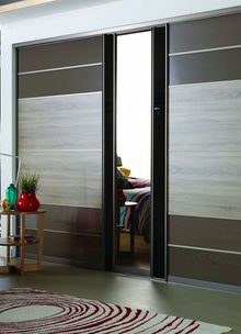 Close-up of grey and wood paneled sliding wardrobe doors