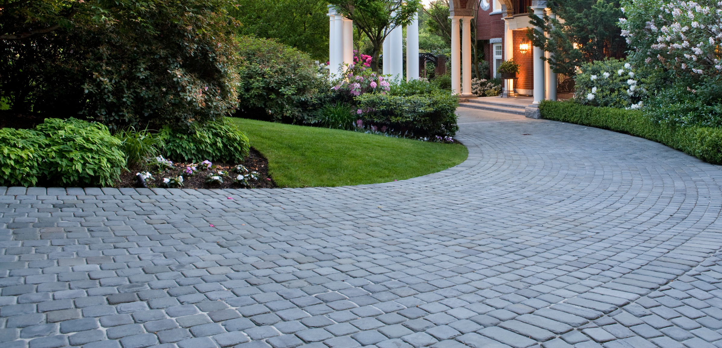 Cobblestone driveway and mansion