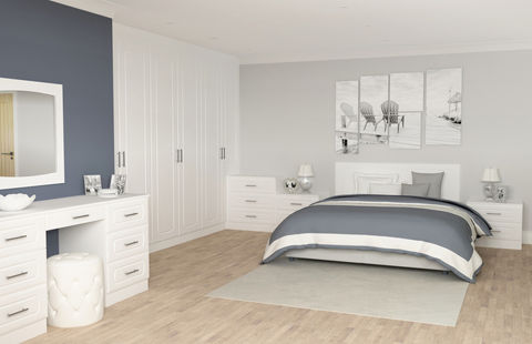 White bedroom suite with a matching dressing table and striped bedding