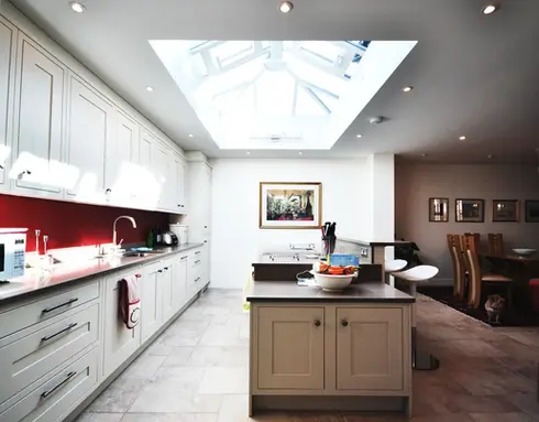 Bright modern kitchen with island and skylight in open plan home