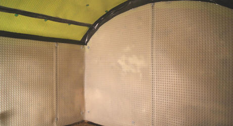 Professional application of studded cavity drain membrane to a curved cellar ceiling