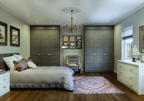 Sophisticated bedroom with olive green wardrobes and a vintage rug