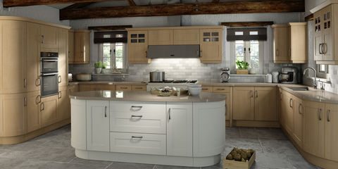 Curved white kitchen island in a room with warm wood cabinetry