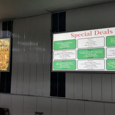 Green and white rectangular projection lightbox extending from a grey panel wall.