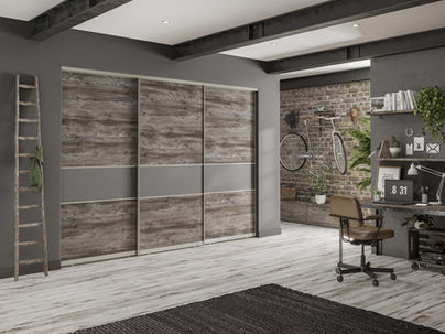 Rustic weathered wood sliding wardrobes in an industrial-style room