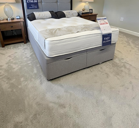 A mattress displayed on a showroom floor, showcasing its design and features for potential customers