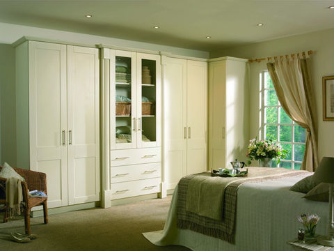 Elegant cream wardrobes with a central glass display cabinet
