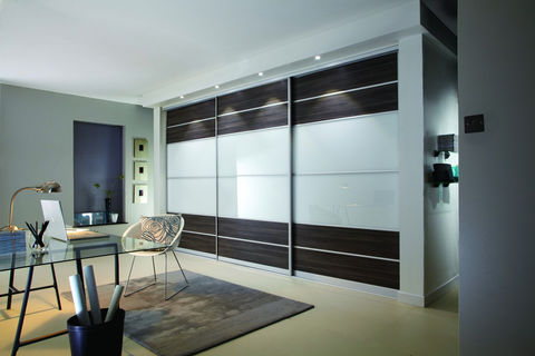 Grey and dark wood sliding wardrobes in a bedroom with a desk