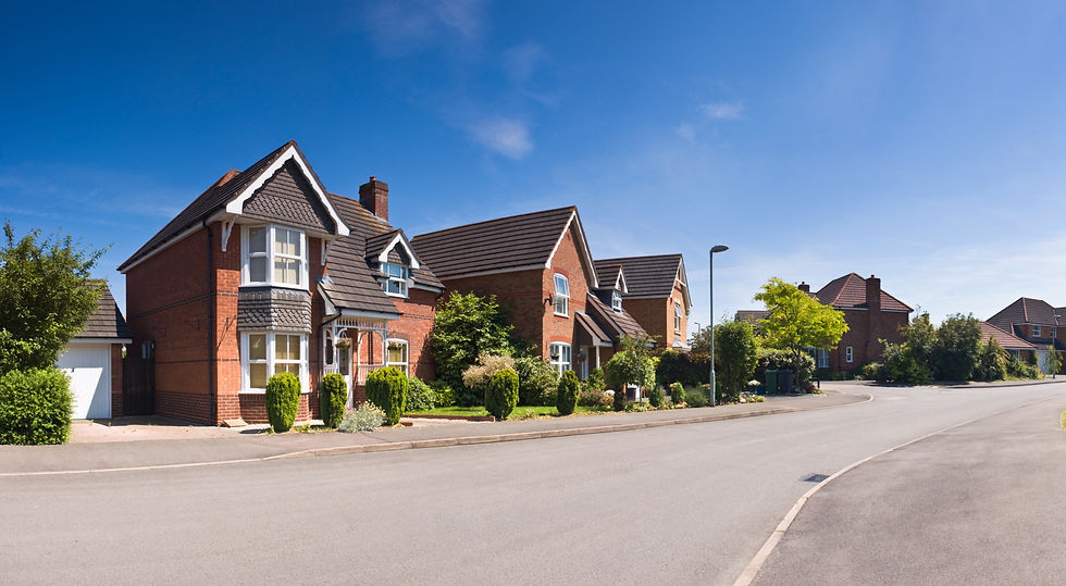 Red brick suburban house under blue sky