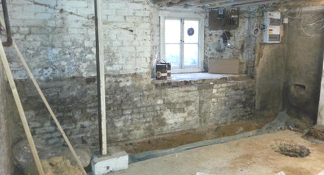 Old brick cellar with small window during strip out