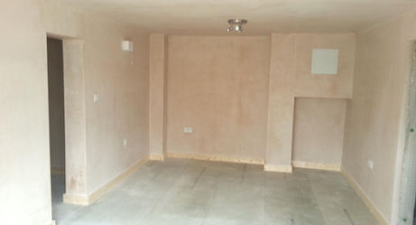 Unfurnished room with bare plastered walls and uncarpeted floor, featuring ceiling spotlights
