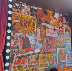 Detailed, multi-colored comic book style wall mural printed across an indoor restaurant wall surface.