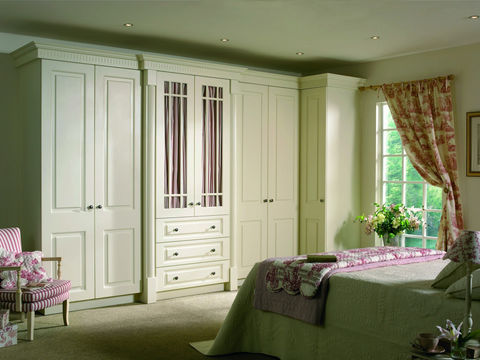 White shaker-style wardrobes with a patterned central glass door