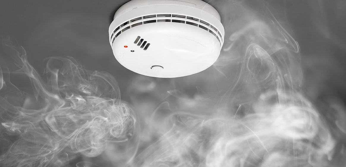 A smoke detector on a ceiling