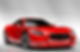 A sleek red sports car with a shiny finish is positioned against a plain gray background