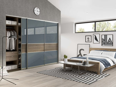 Sliding wardrobes with blue and wood panels in a rustic bedroom