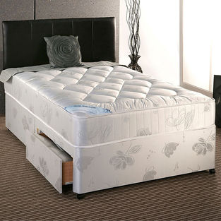 Divan bed with a patterned base and under-bed storage drawer pulled out