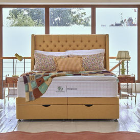 Light wooden storage divan bed with drawers built into the base