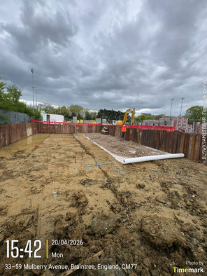Smooth concrete slab with green and brown pipes emerging