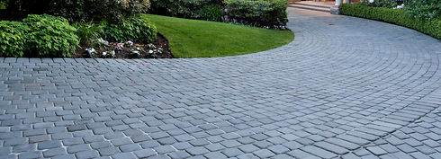 Cobblestone driveway and mansion