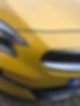 Bumper of a yellow car standing on road
