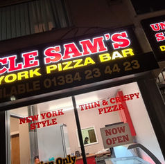 Storefront signage reading "UNCLE SAM'S" in bold white lettering against a dark fascia panel.