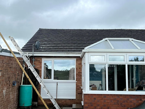 View of a house roof and conservatory extension