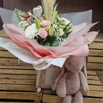 A soft pink and white floral bouquet with dried pampas grass