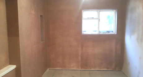 Basement room with fresh plaster applied to walls